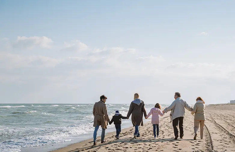 Photo of a family walking on the beach
