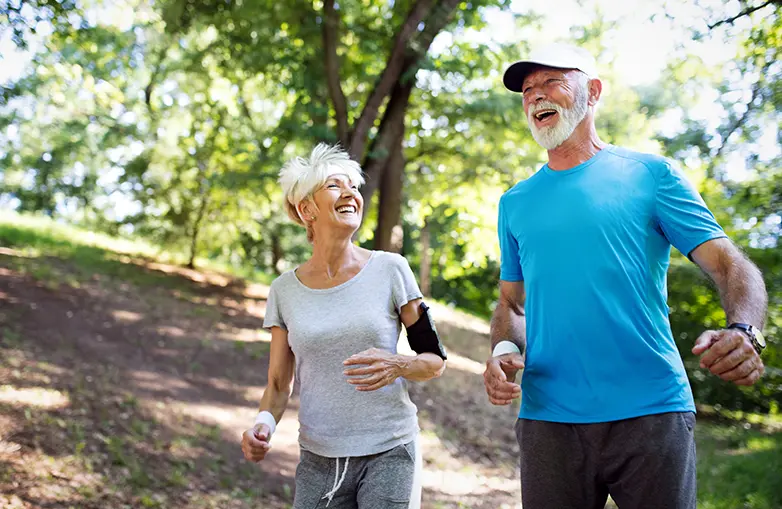 Photo of a senior couple running in the park